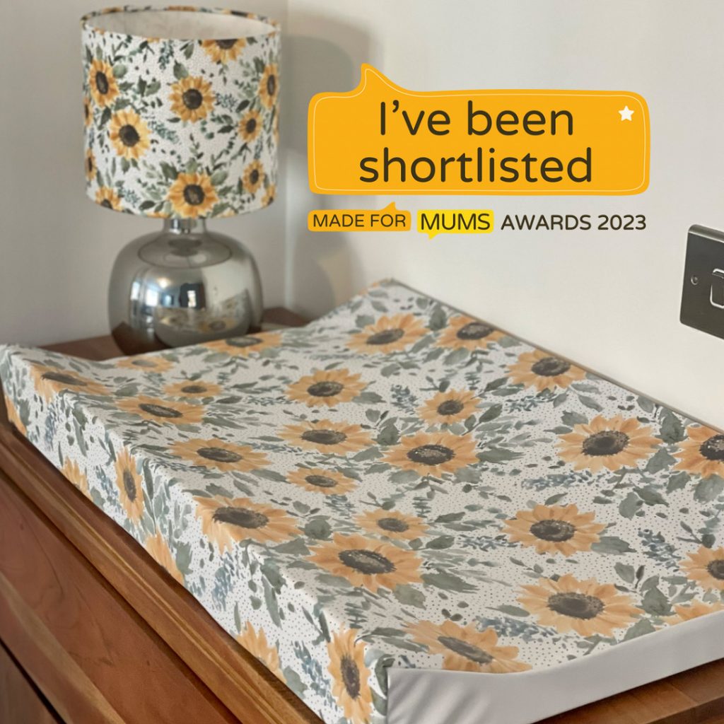 sunflower wedge changing mat with text "ive been shortlisted made for mums awards 2023"