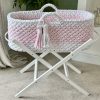 Pink and white crochet moses basket on a white foldable stand