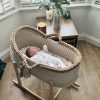 hooded crochet moses basket with a baby lying inside