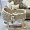 Hooded crochet moses basket in vanilla and beige, with a matching changing basket on a natural stand