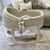 Hooded crochet moses basket in vanilla and beige, with a matching changing basket on a natural stand