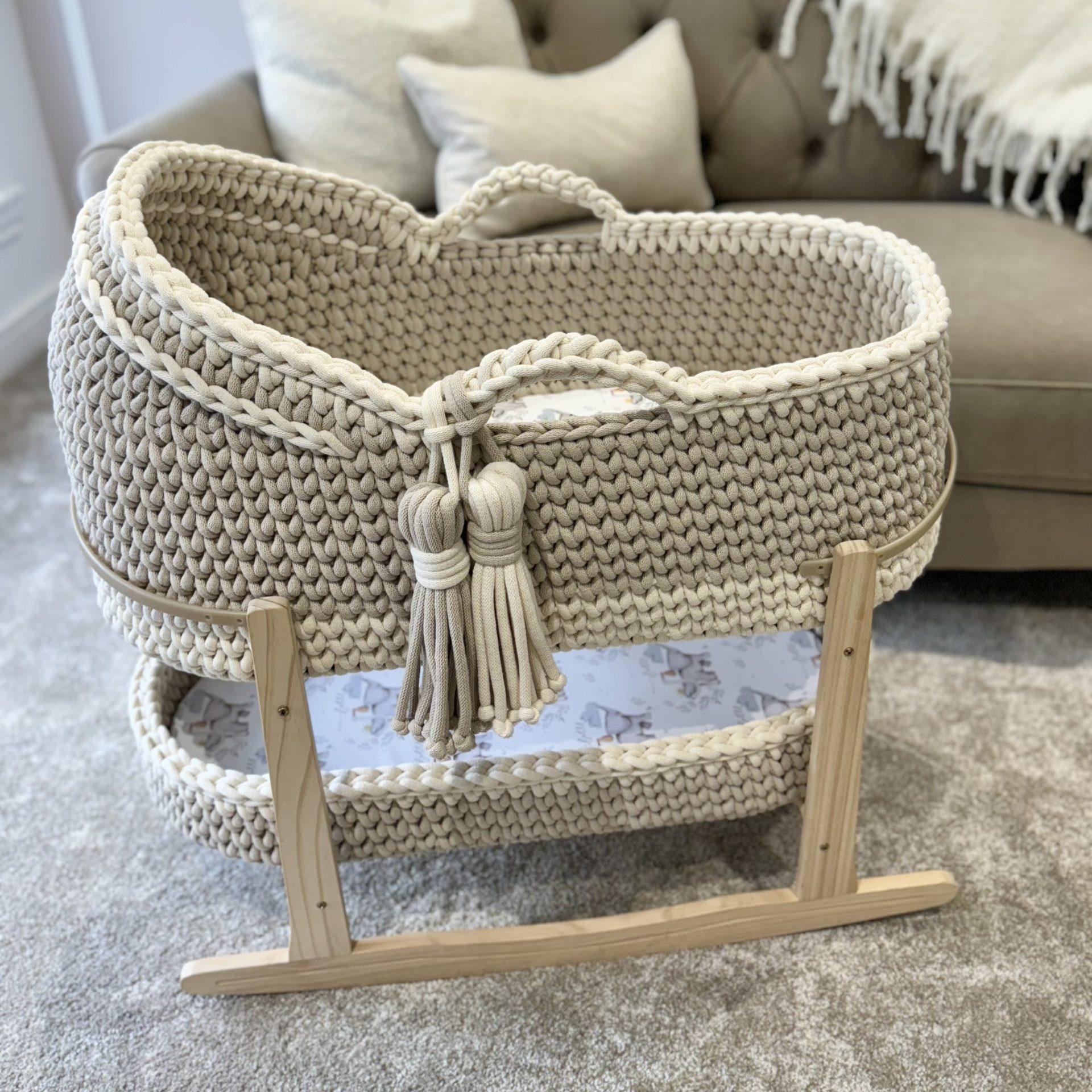 Hooded crochet moses basket in vanilla and beige, with a matching changing basket on a natural stand