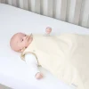 baby wearing cream organic cotton sleeping bag